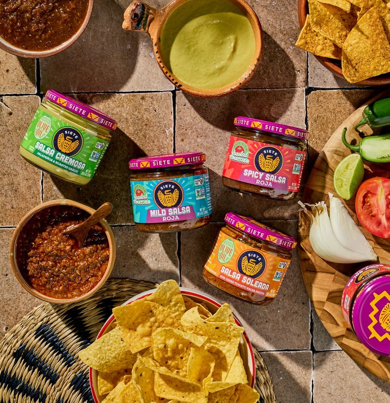 salsa jar laying flat with chips and salsa