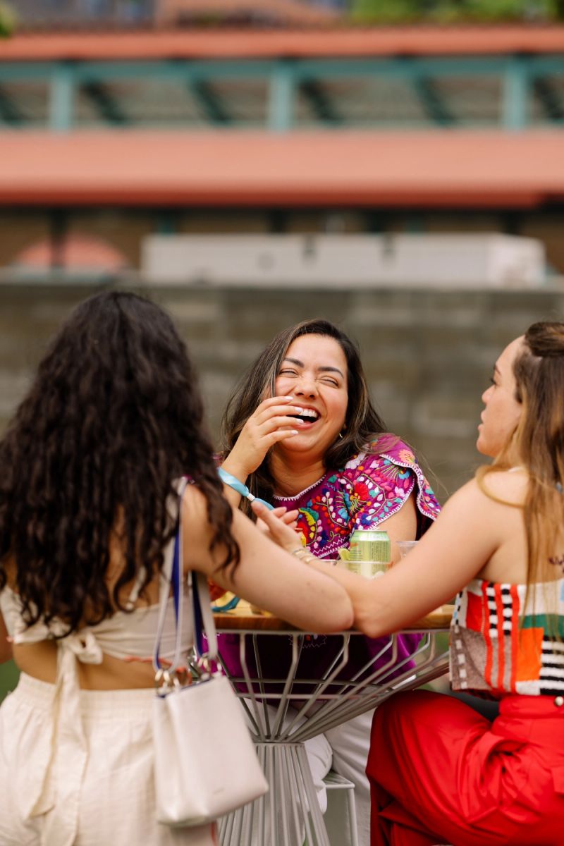 a group gathered around table laughing 
