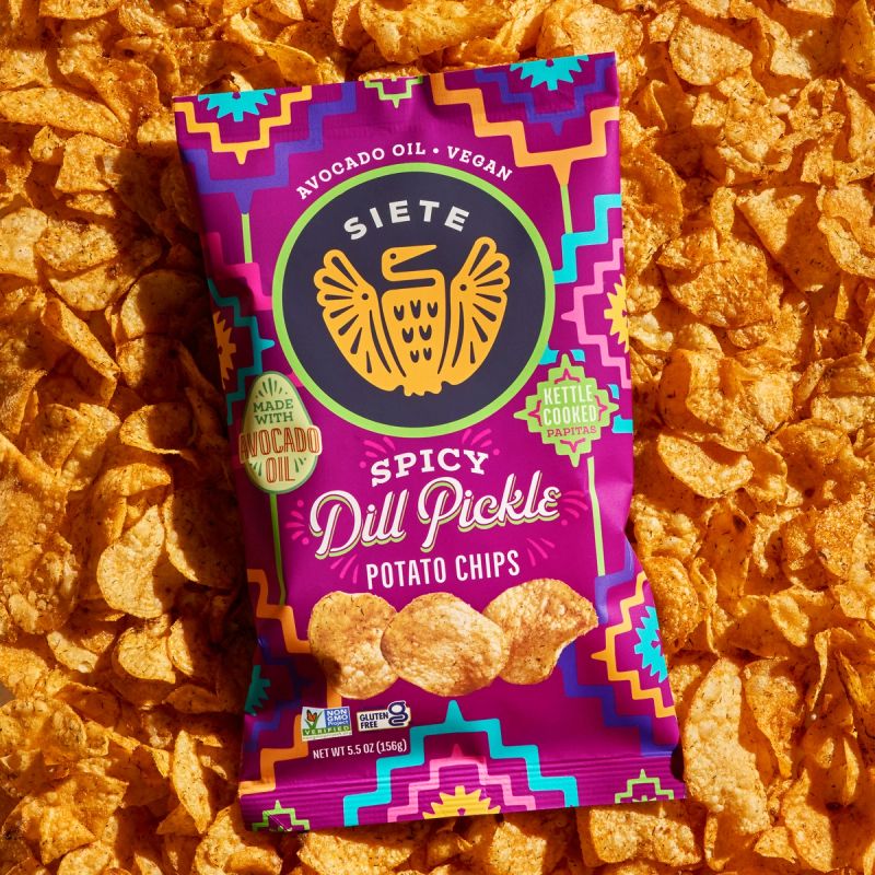 a package of Spicy Dill Pickle potato chips on a background of chips