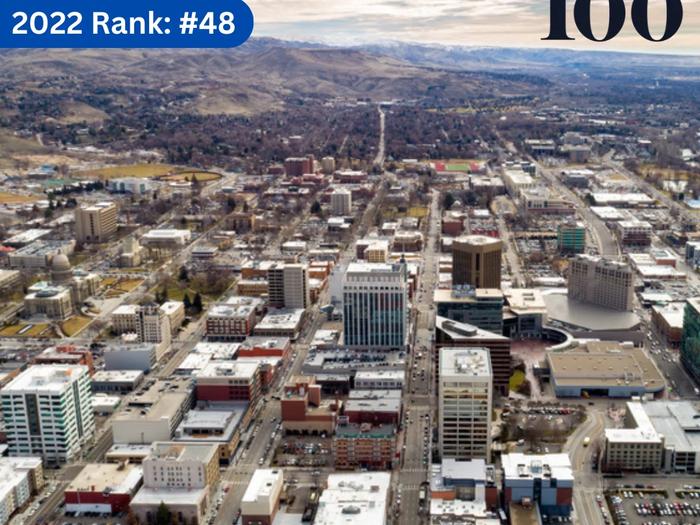 Aerial view of downtown Boise with mountains in the distance, marked with '2023 Rank: #38' and 'Idaho 100' graphics