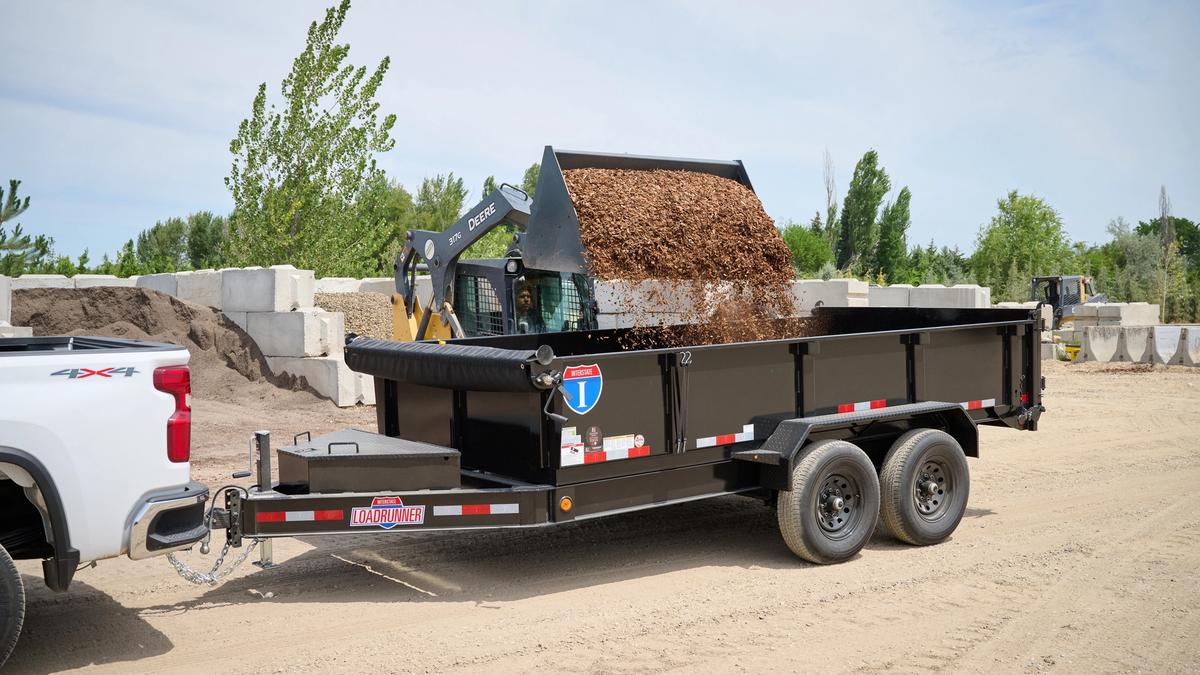 Dump trailer with mulch loading in from a skidsteer