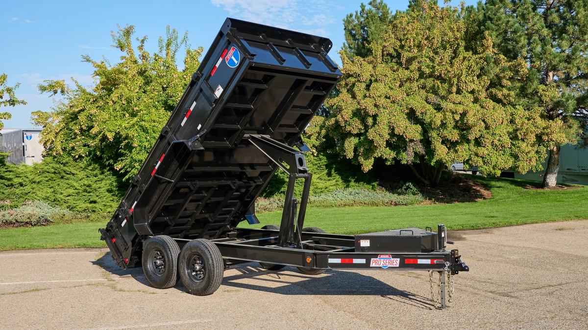 Dump trailer with bed extended upward