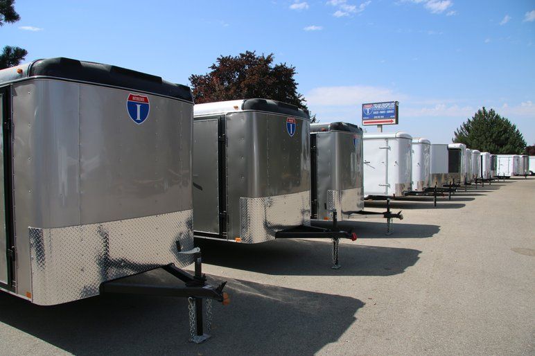 Lineup of cargo trailers with a blue sky