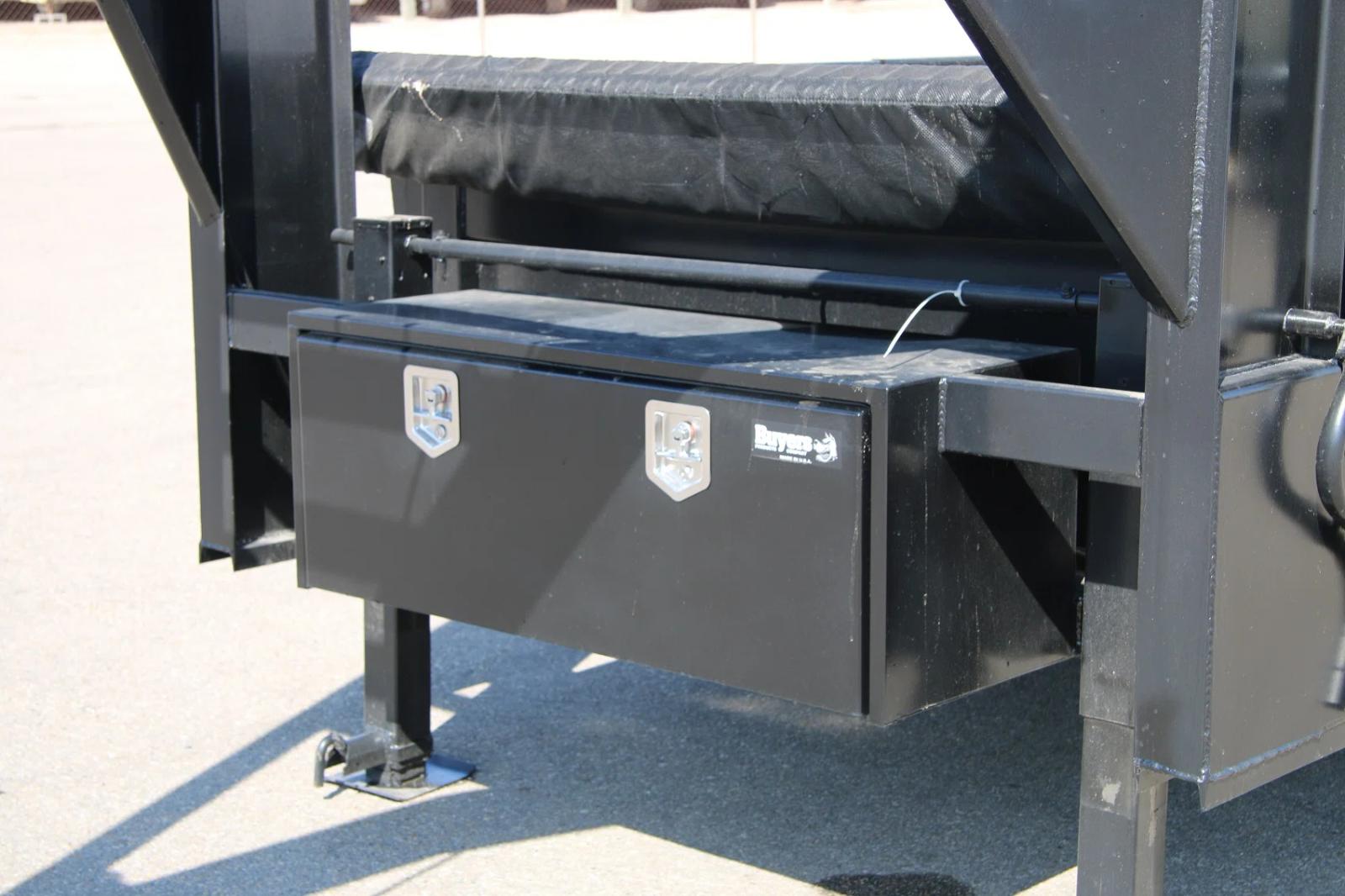 Close-up of a black Buyers Products gooseneck tongue toolbox mounted beneath the neck of a black gooseneck trailer