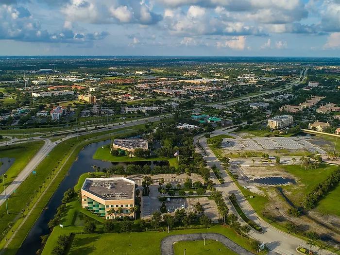 Aerial view of a Florida suburban office park with greenways, retention ponds, and mid-rise commercial buildings