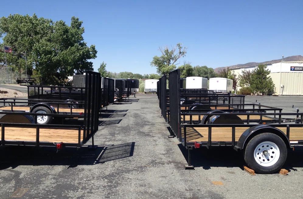 Utility trailers lined up in dealership parking lot
