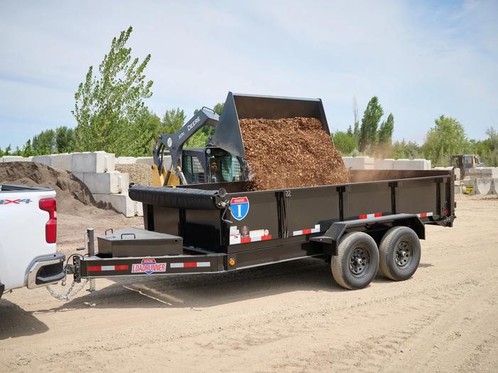 Dump trailer with mulch loading in from a skidsteer