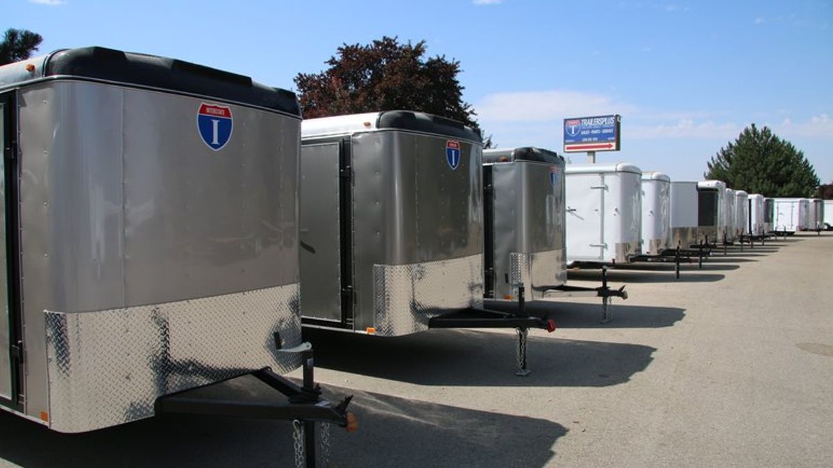 Cargo trailers in a row with blue skies