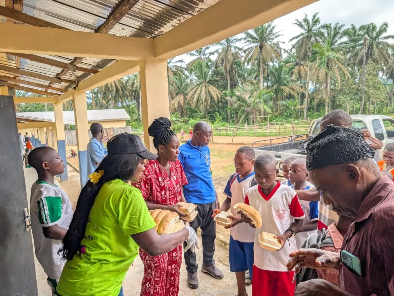 Volunteers handing out bread and meals to pupils