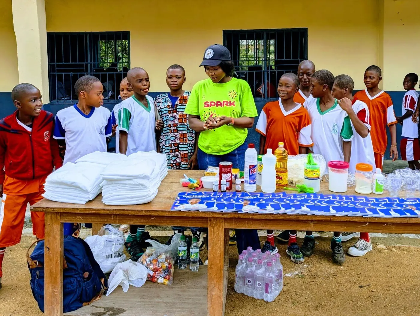 A volunteer with a group of pupils at a table of science materials