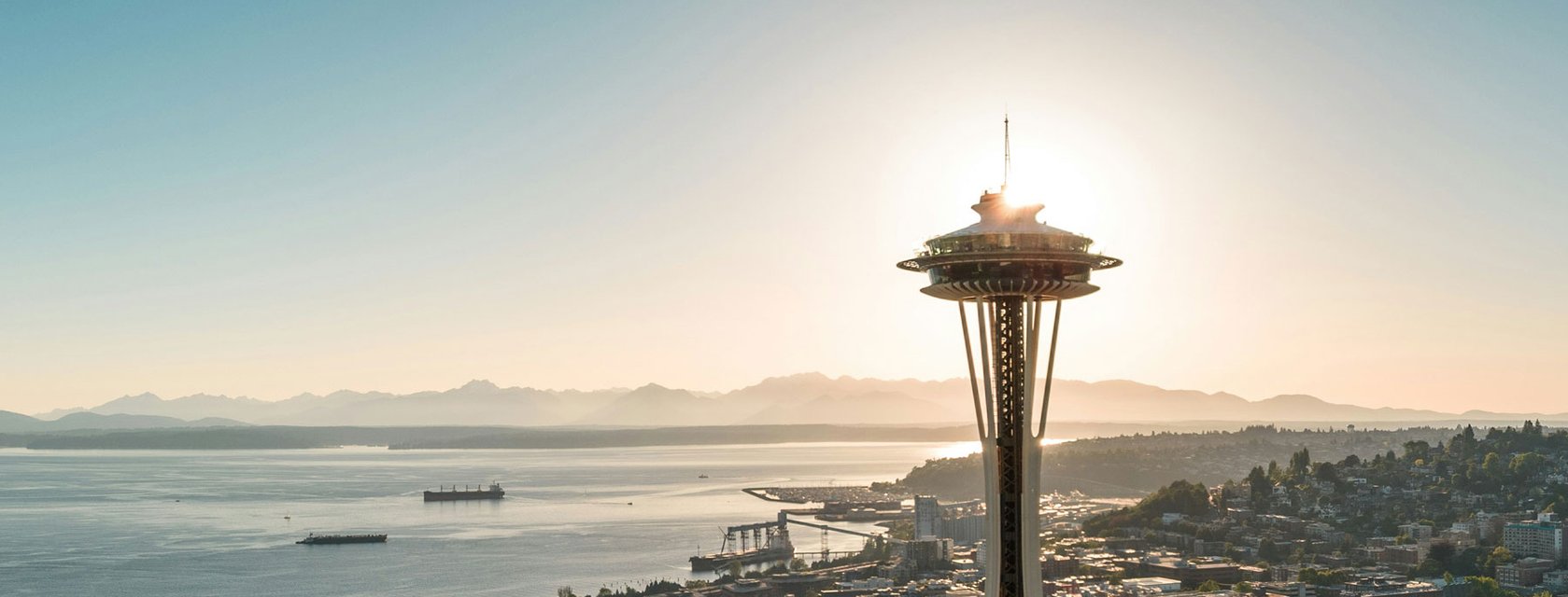 Seattle’s Space Needle overlooking the city and Puget Sound at sunset