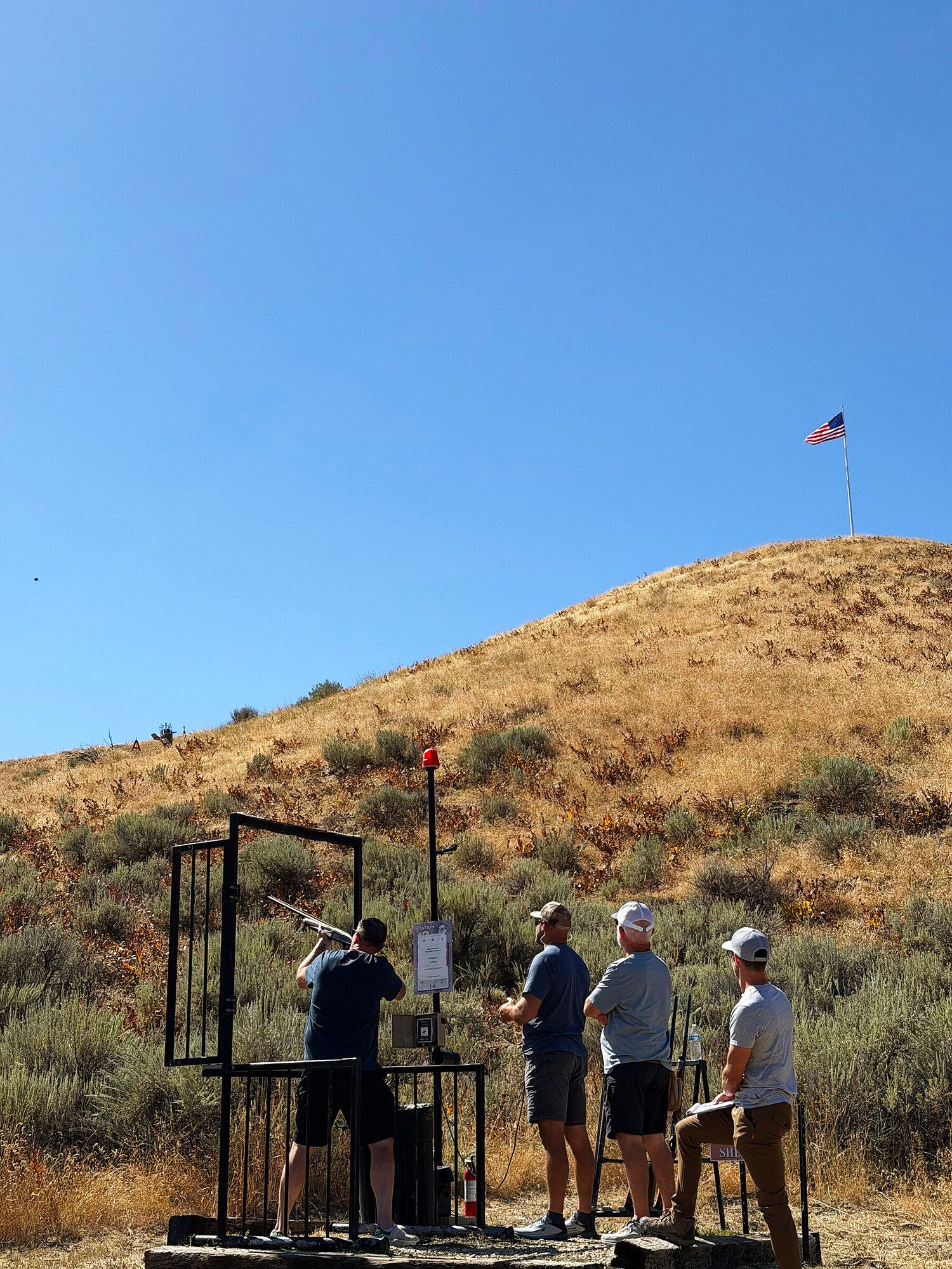 Guests shooting sporting clays at a station in the Idaho hills