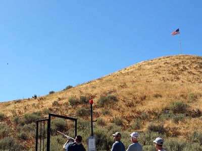 Guests shooting sporting clays at a station in the Idaho hills
