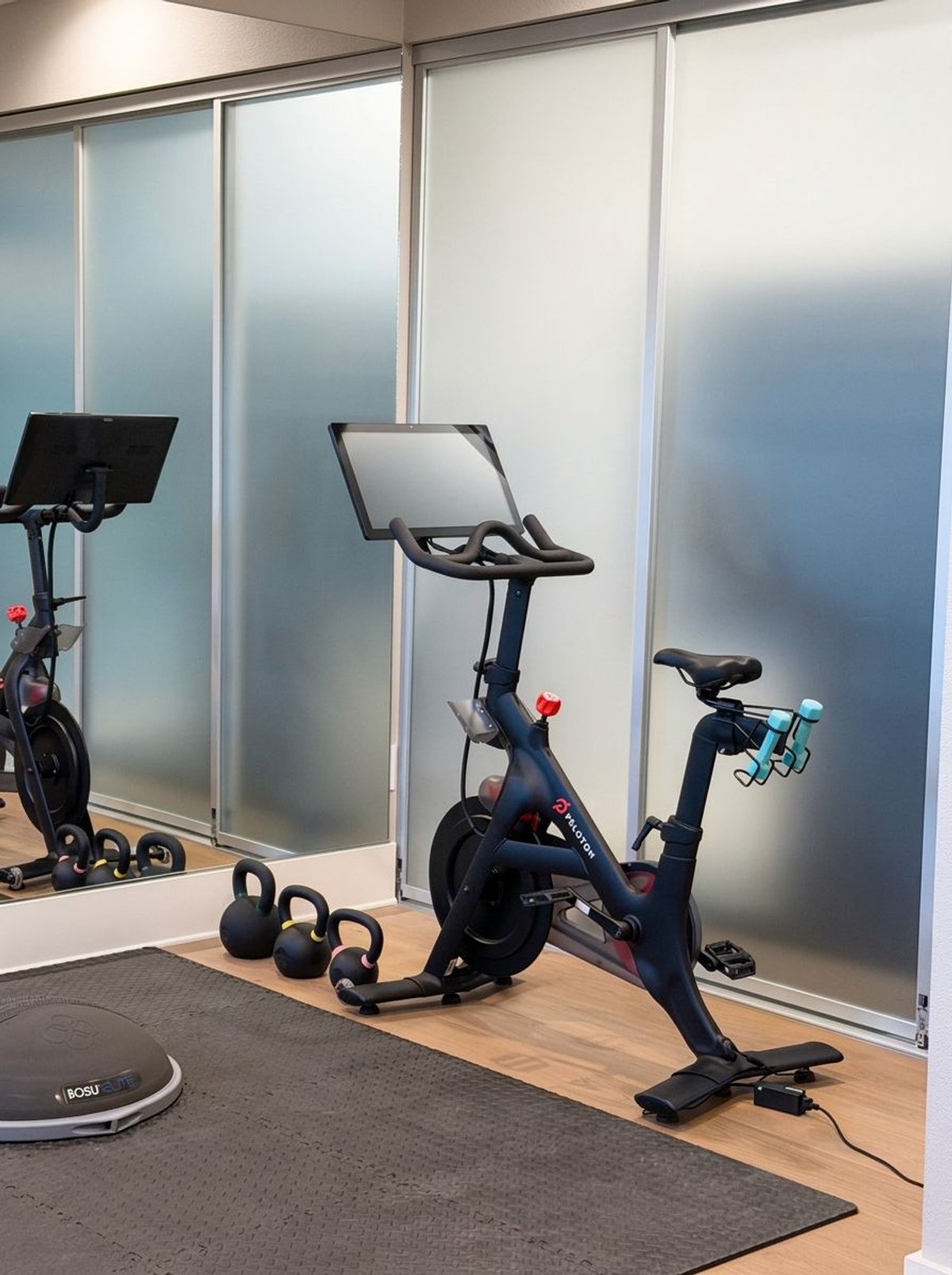 Guest fitness space with an exercise bike and weights
