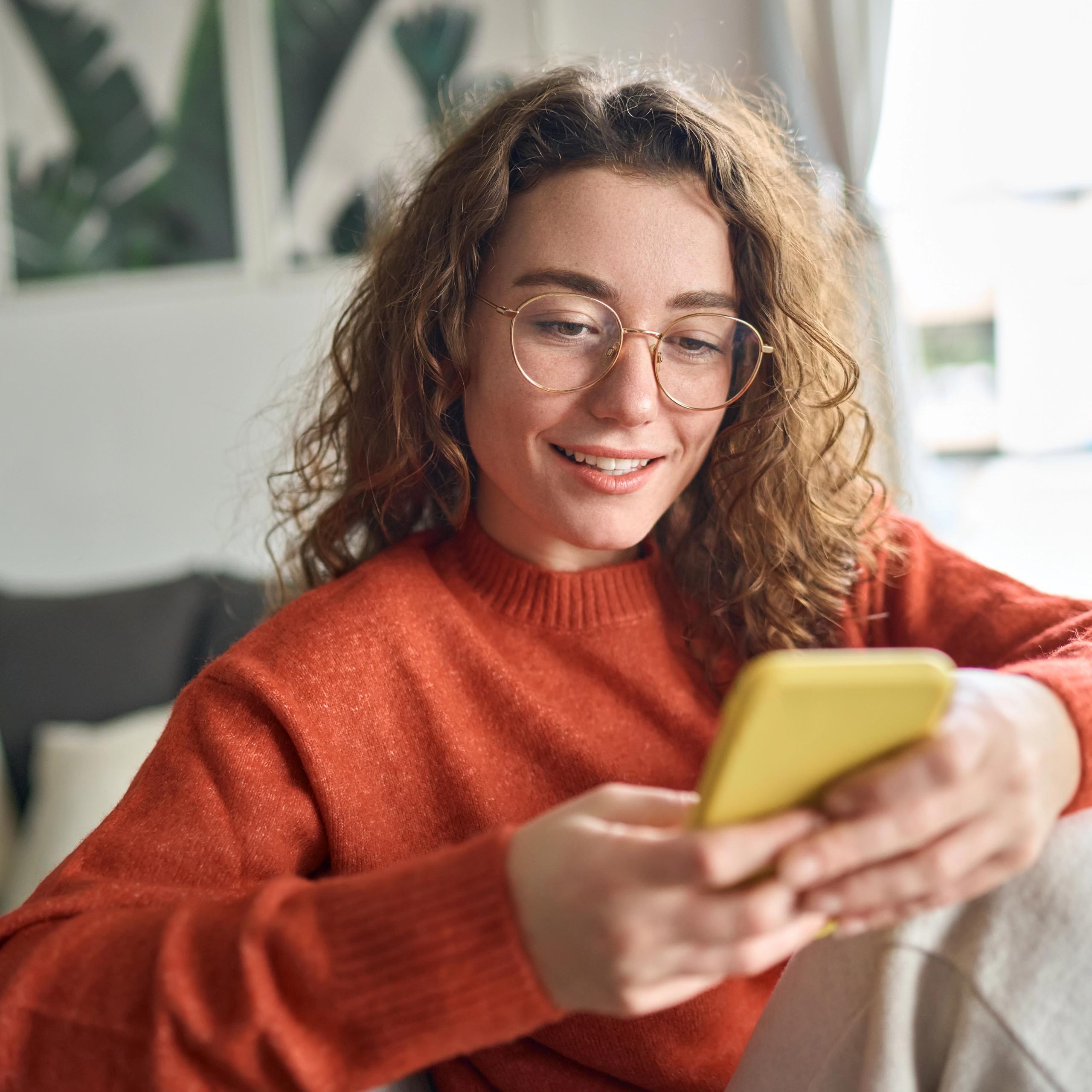 Checking the loan status on her mobile phone