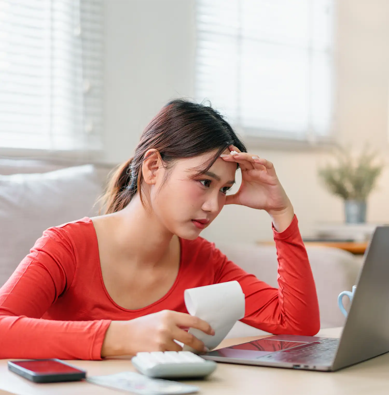 Woman checking her finances at home
