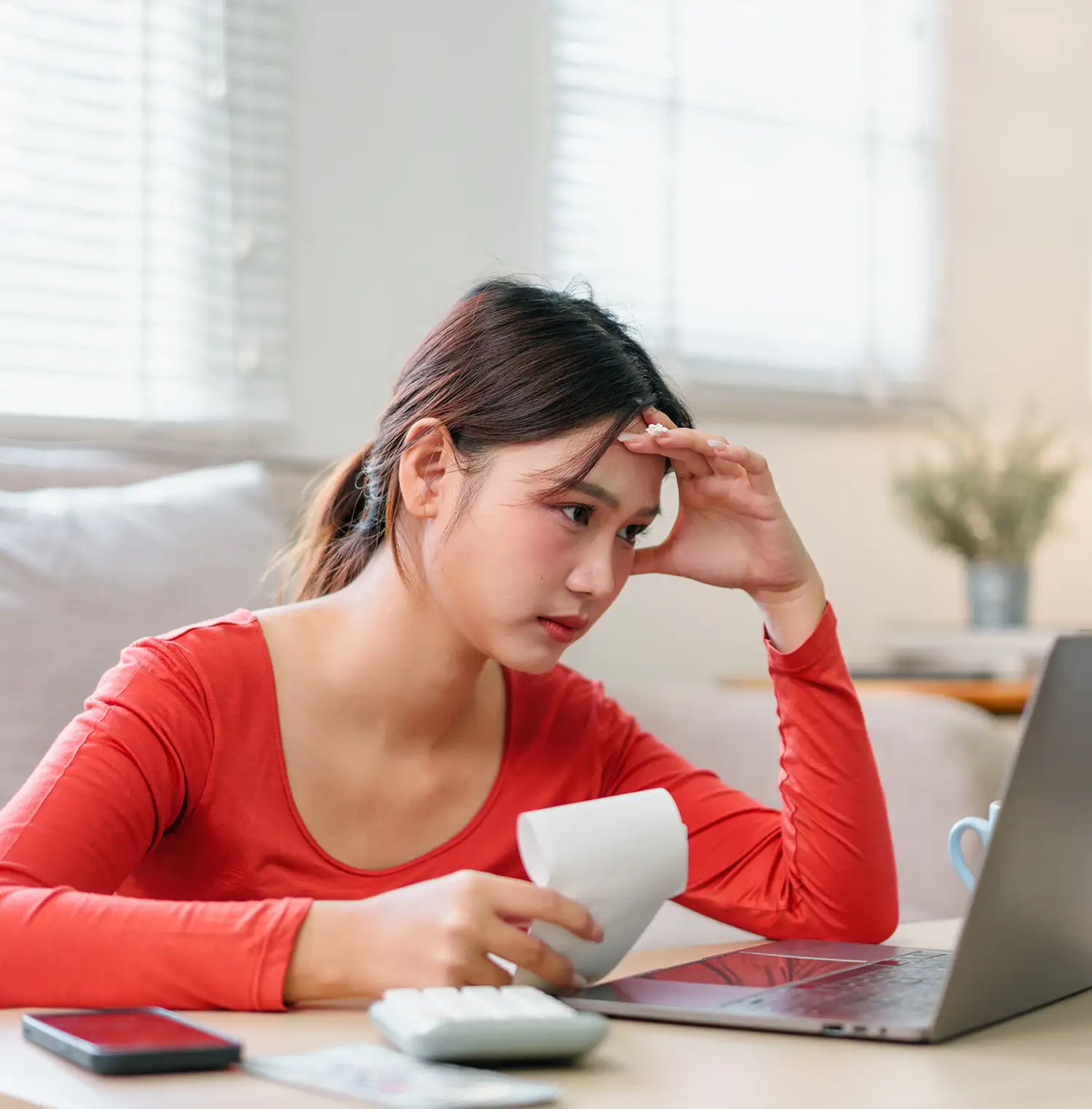 Woman checking her finances at home