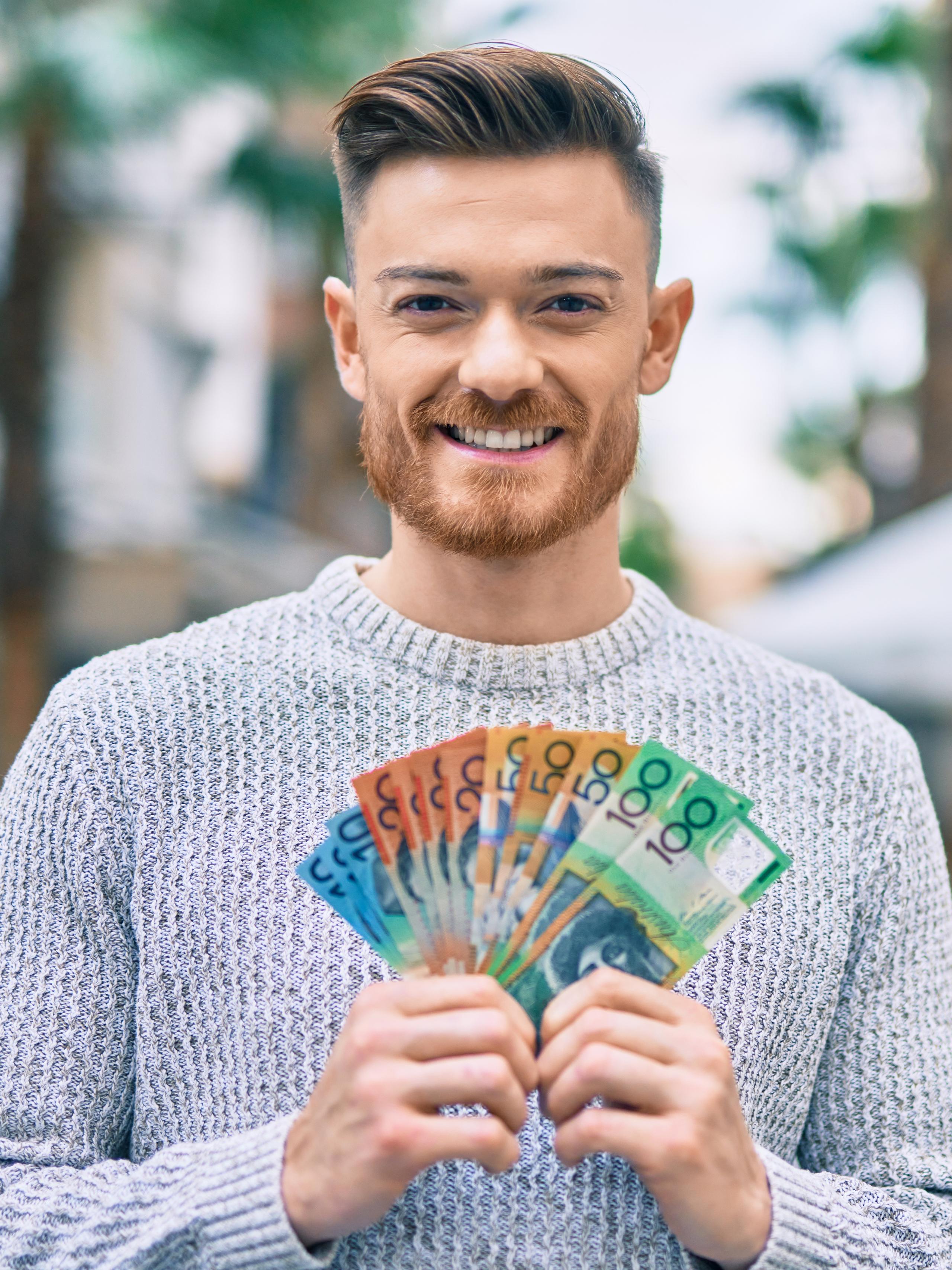 Young man with a wad of cash