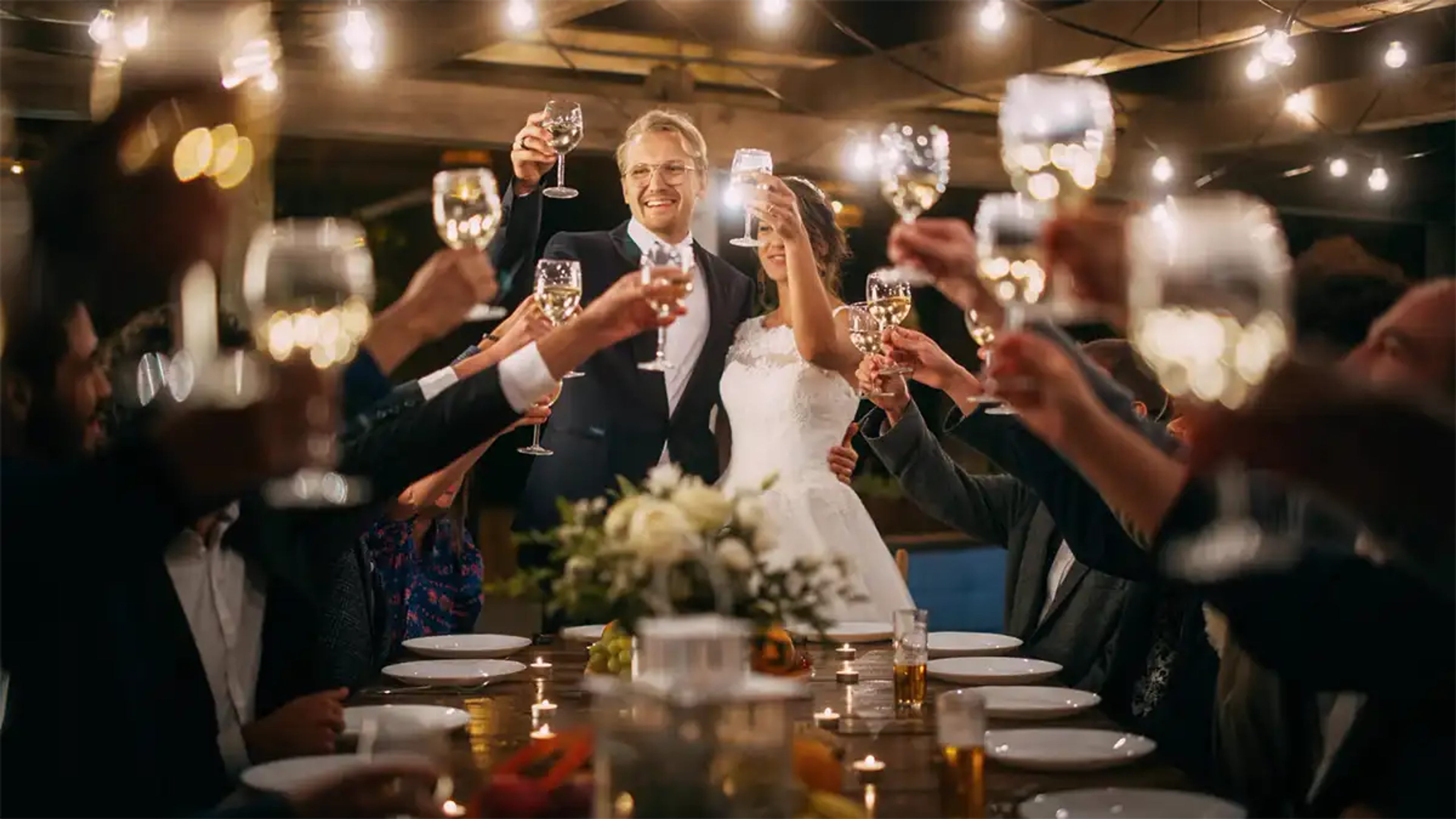 Wedding toast to the bride and groom at the head of the table