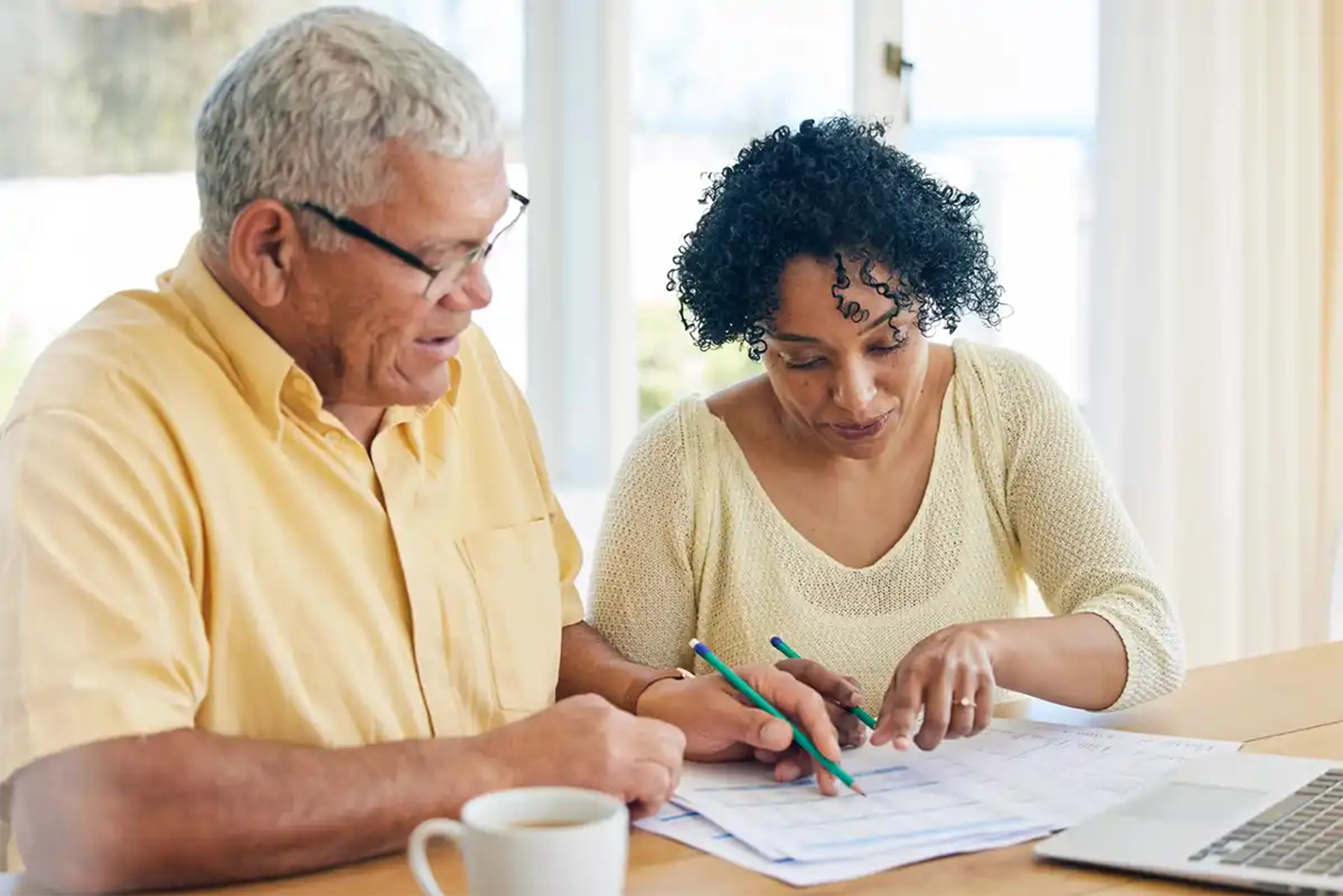 Middle aged couple budgeting at the table