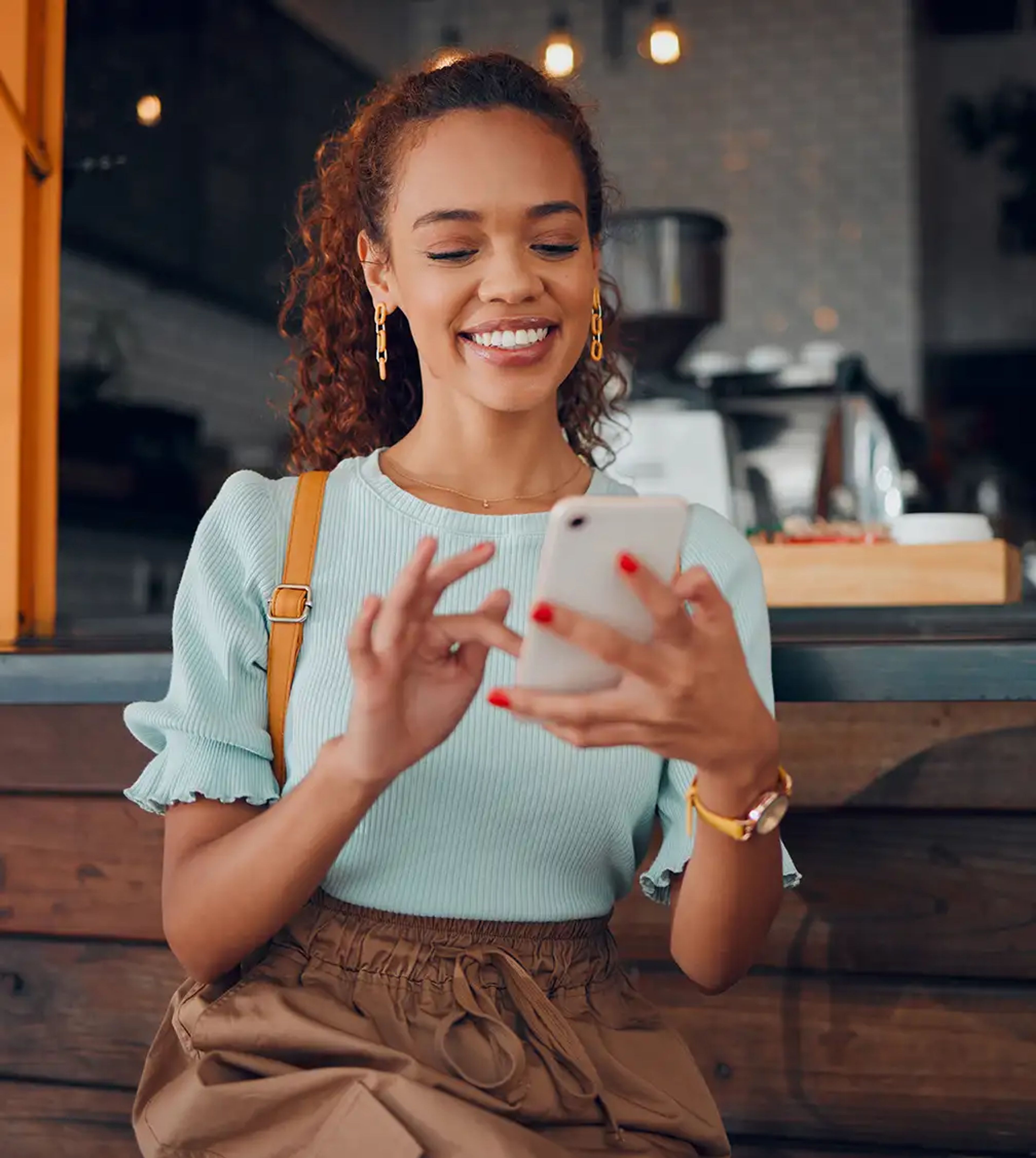 Young happy woman checking her mobile