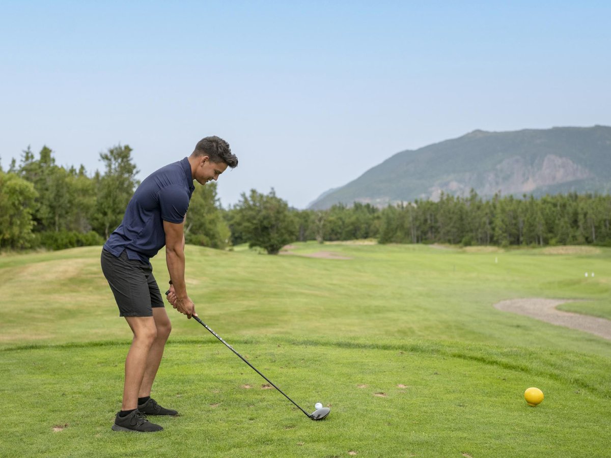 Golfer teeing off