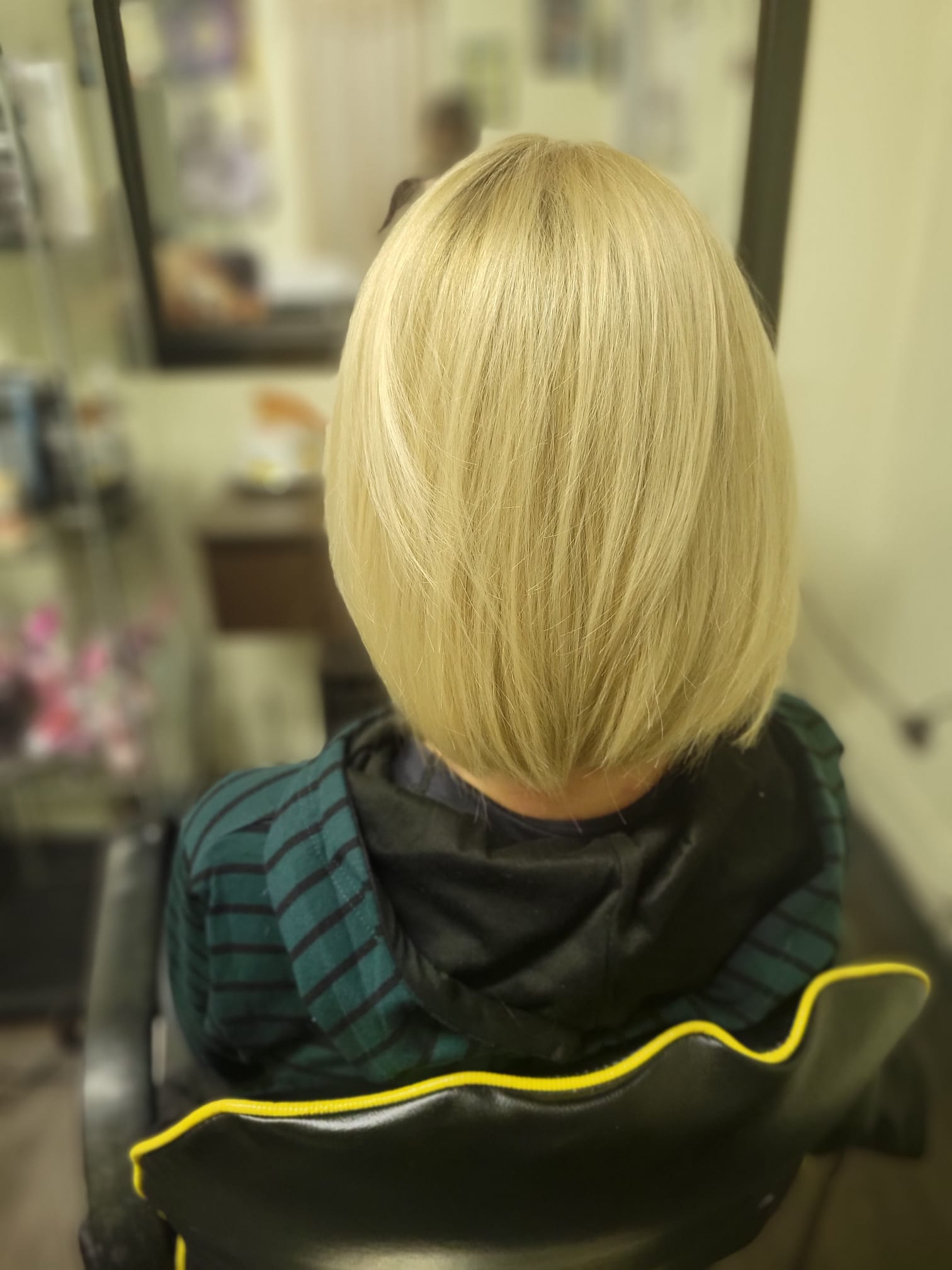 sleek, chin-length bob with soft layers at the ends for added movement. The hair is smooth and shiny, styled to frame the face with a slight inward curve at the bottom.