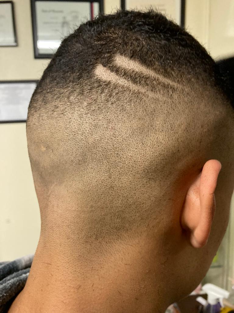 Haircut facing the back with two stroke marks trimmed into the hair