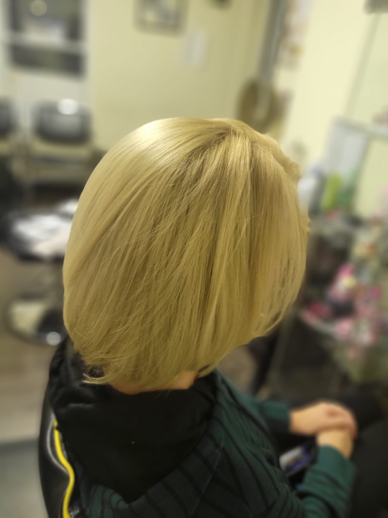 sleek, chin-length bob with soft layers at the ends for added movement. The hair is smooth and shiny, styled to frame the face with a slight inward curve at the bottom.