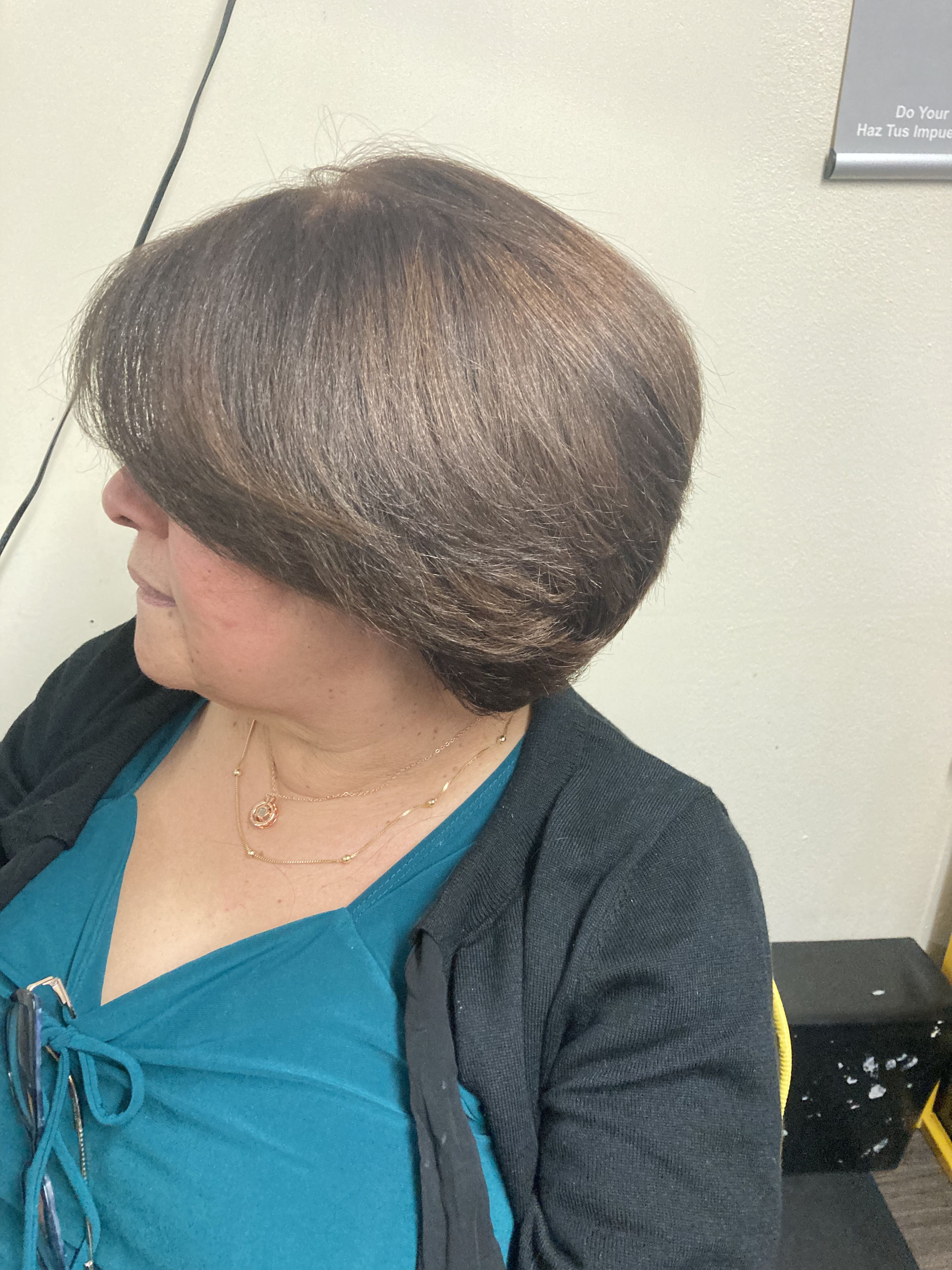 Woman with a short, layered bob haircut. Soft, rounded shape that curves inwards at the ends. The hair is smooth and shiny, framing the face gently
