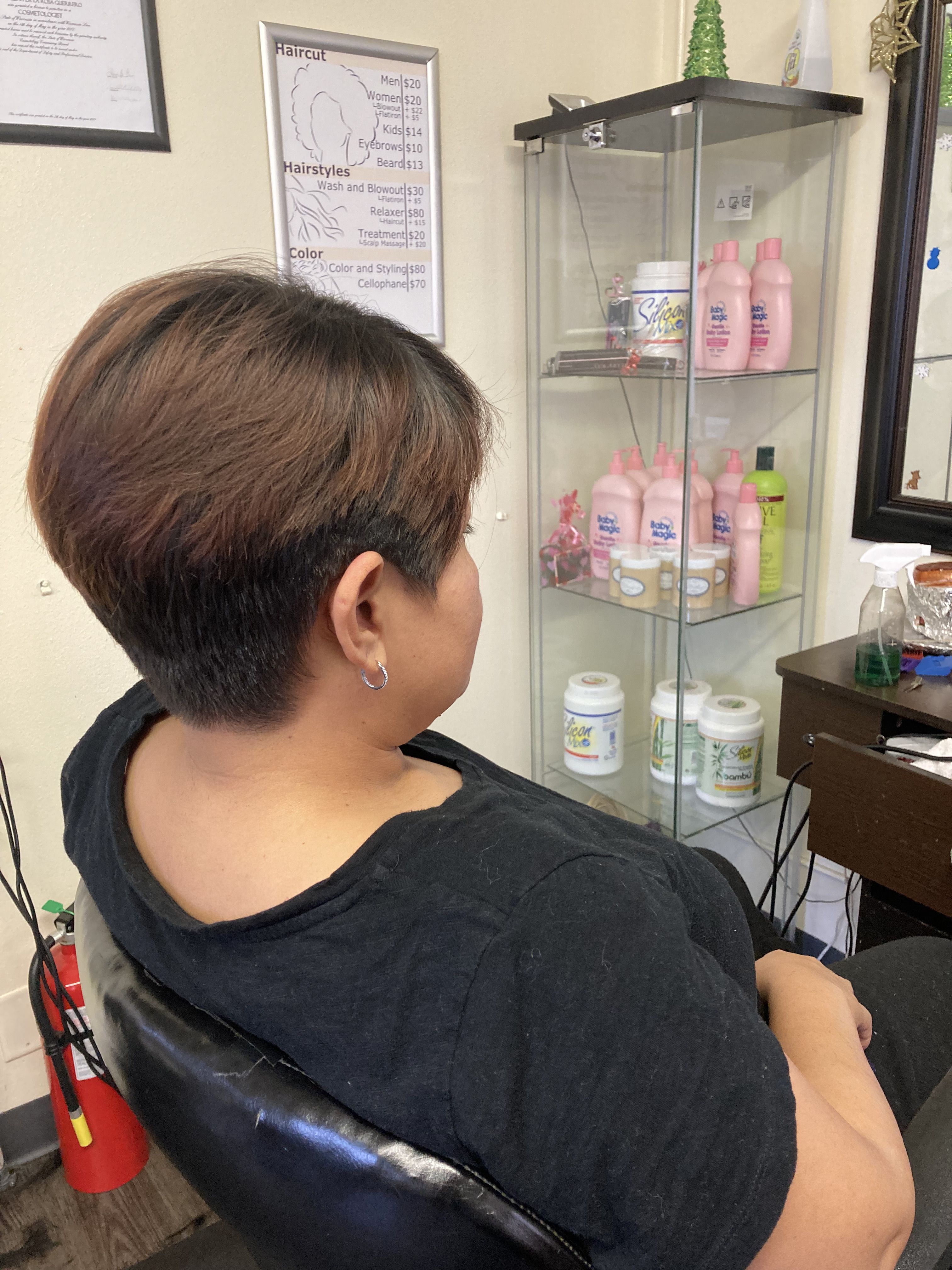 with a short, bowl-cut hairstyle. The hair is layered, with the top section being longer and the bottom section closely shaved.