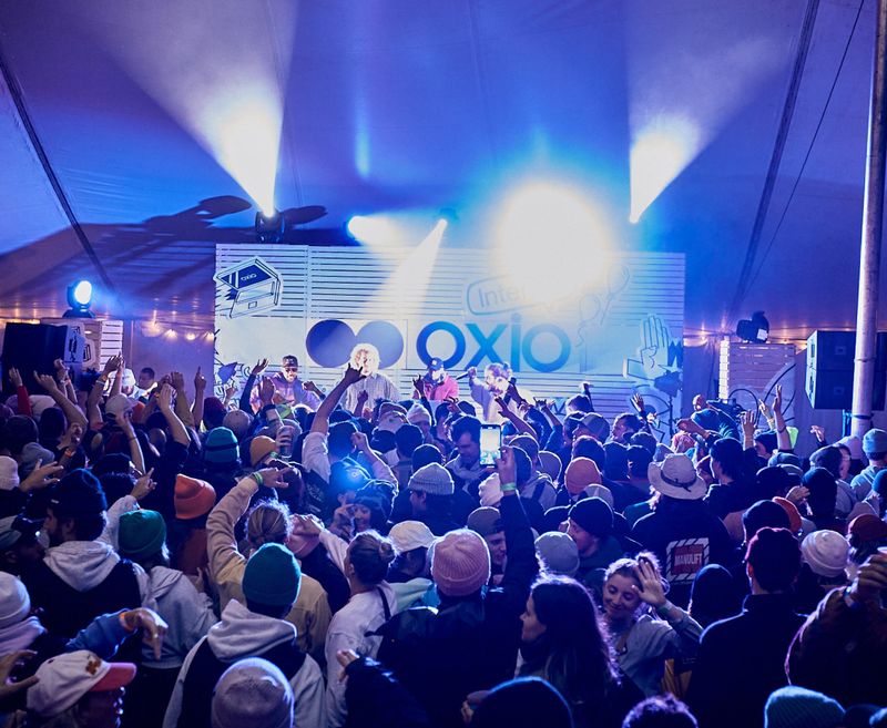 People cheering at a concert on the oxio stage.