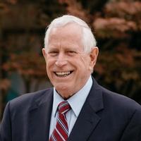 Rev. Dr. Tom Tewell, Preacher in Residence & Pastoral Residency Advisor. A smiling older man in a navy suit jacket.
