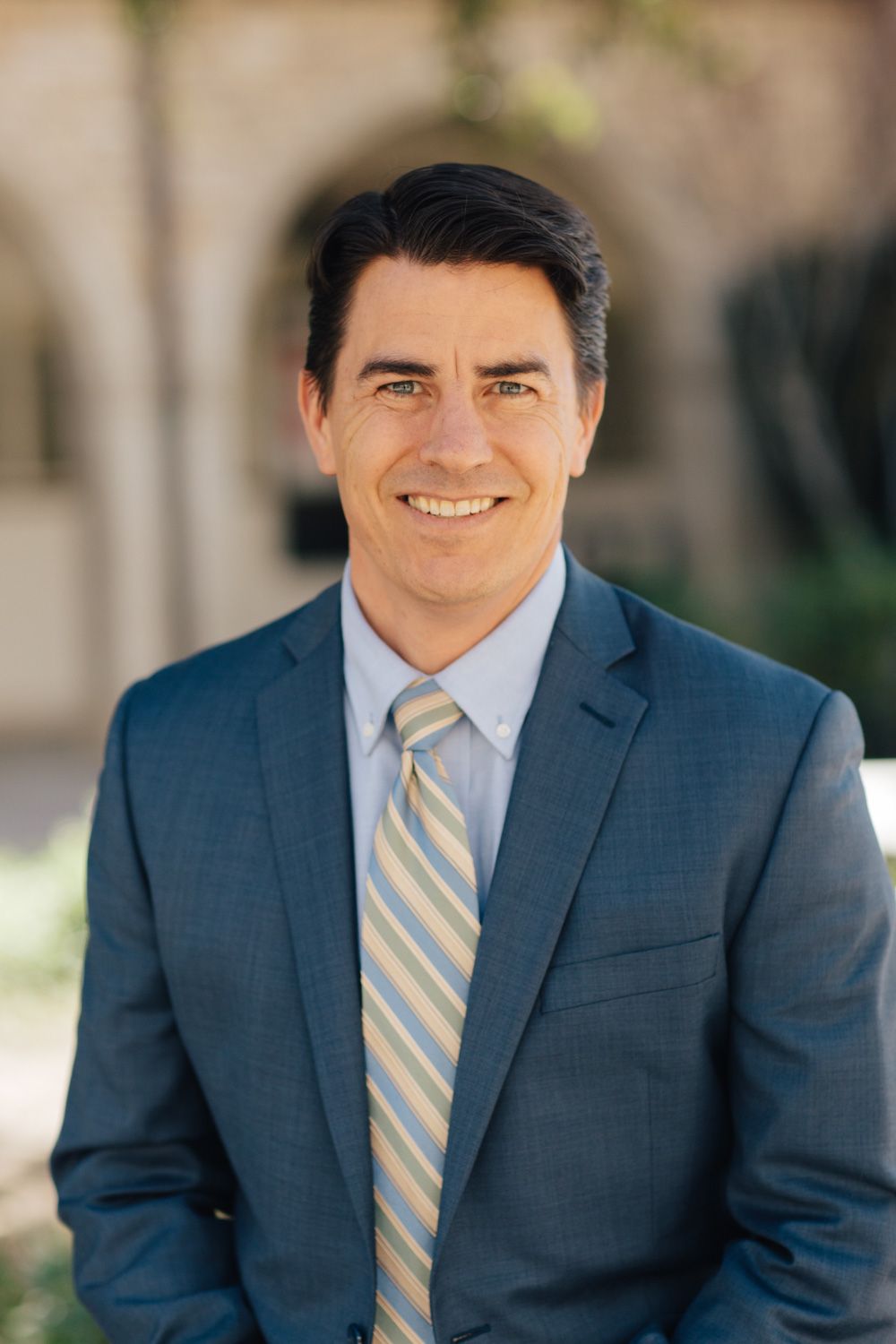 Rev. Dr. Erik Wiebe, Associate Pastor for Spiritual Formation & Pastoral Care. A smiling brow-haired man in a blue suit.