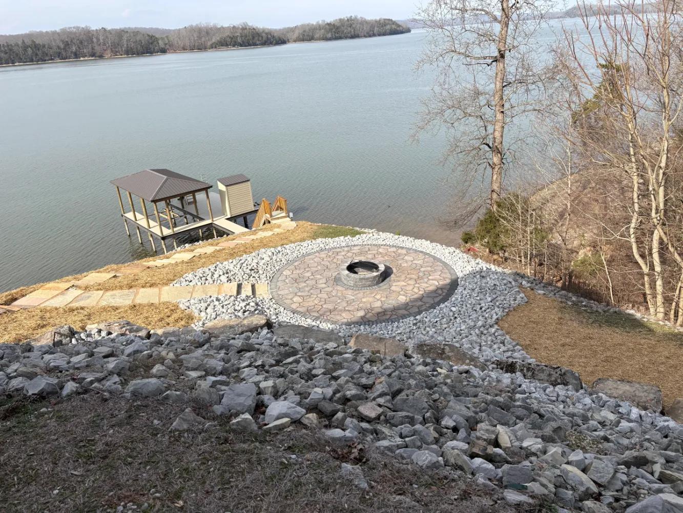 Outdoor patio with fireplace overlooking lake