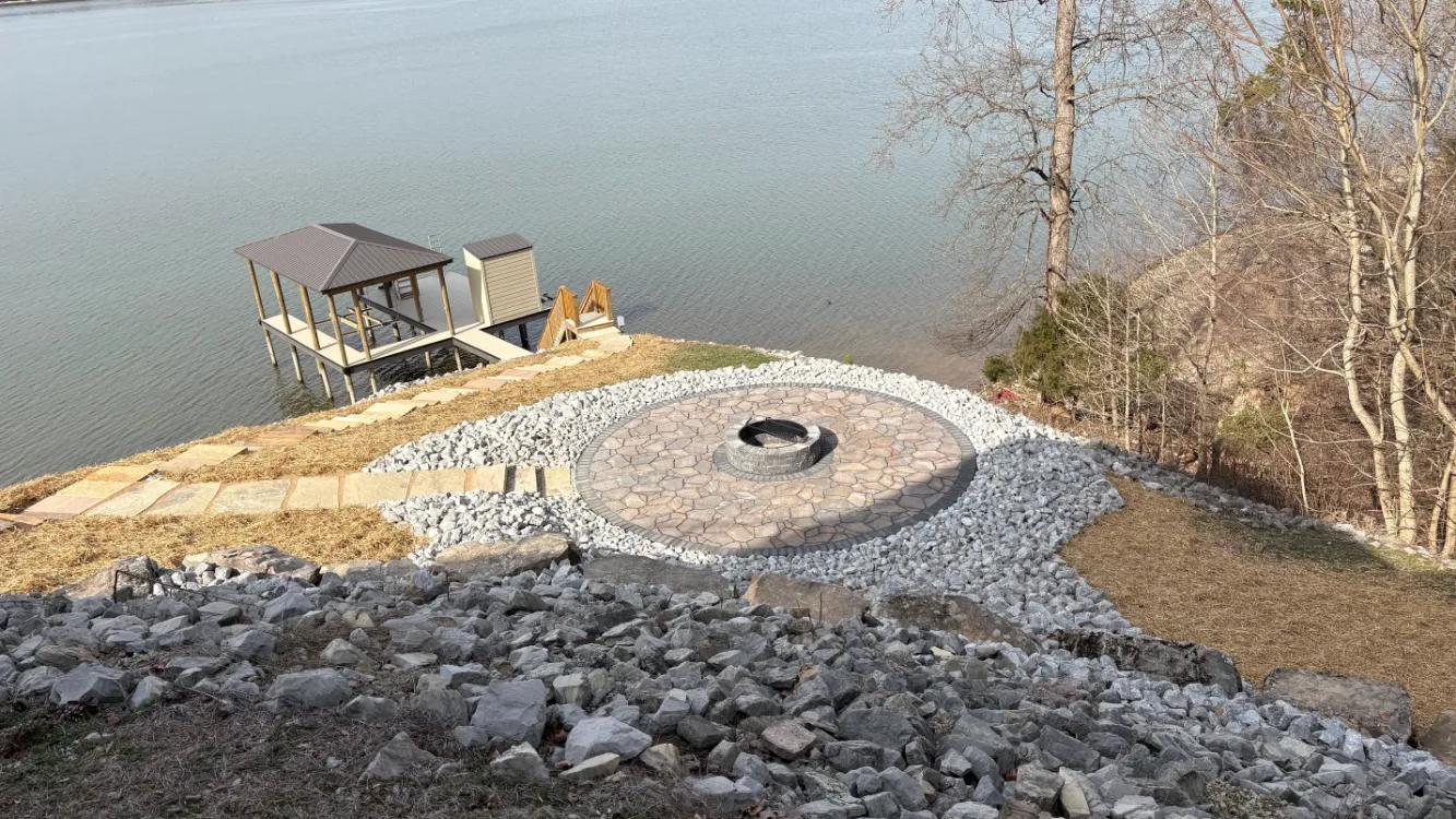 Outdoor patio with fireplace overlooking lake
