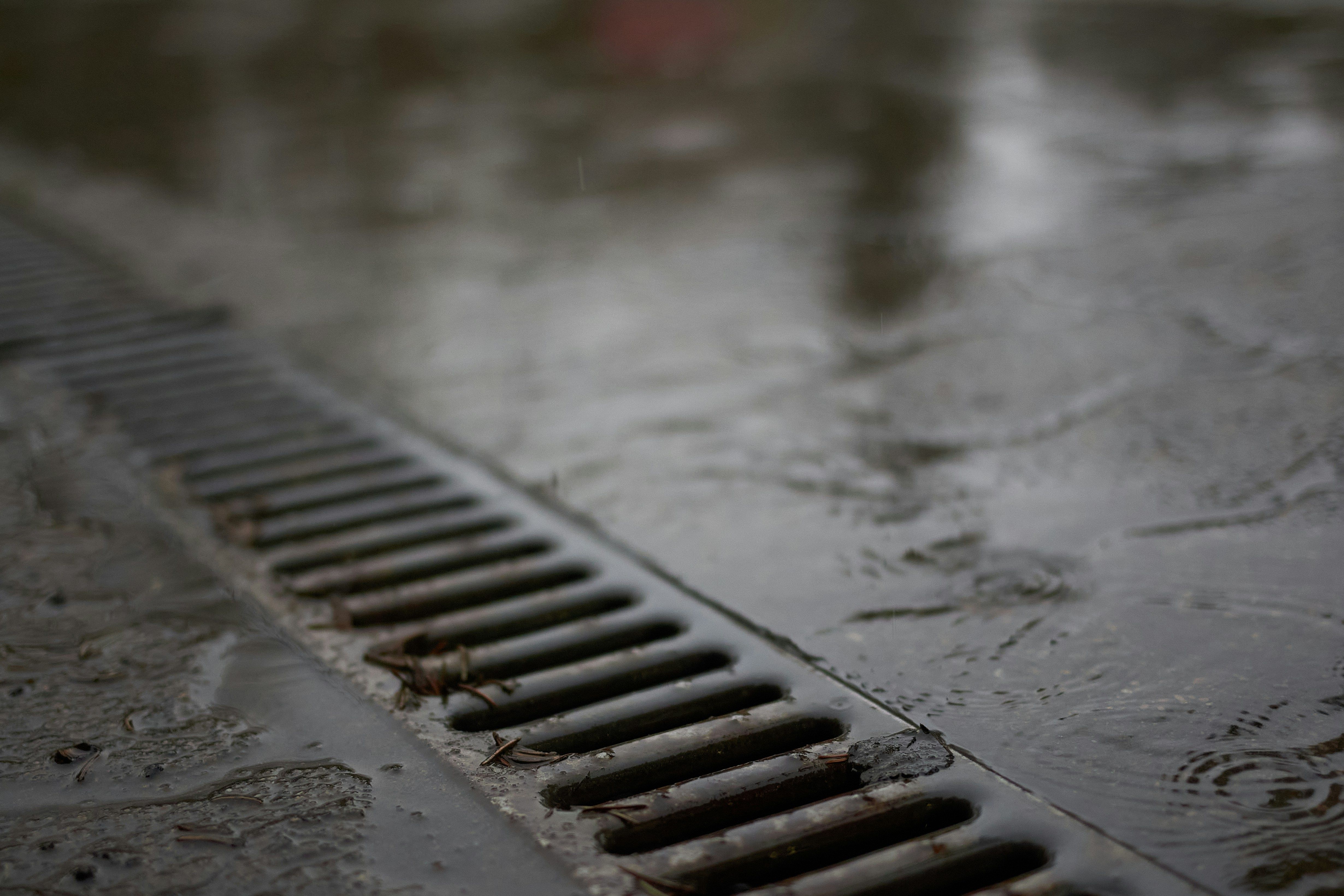 Drain up close with rain flowing into it