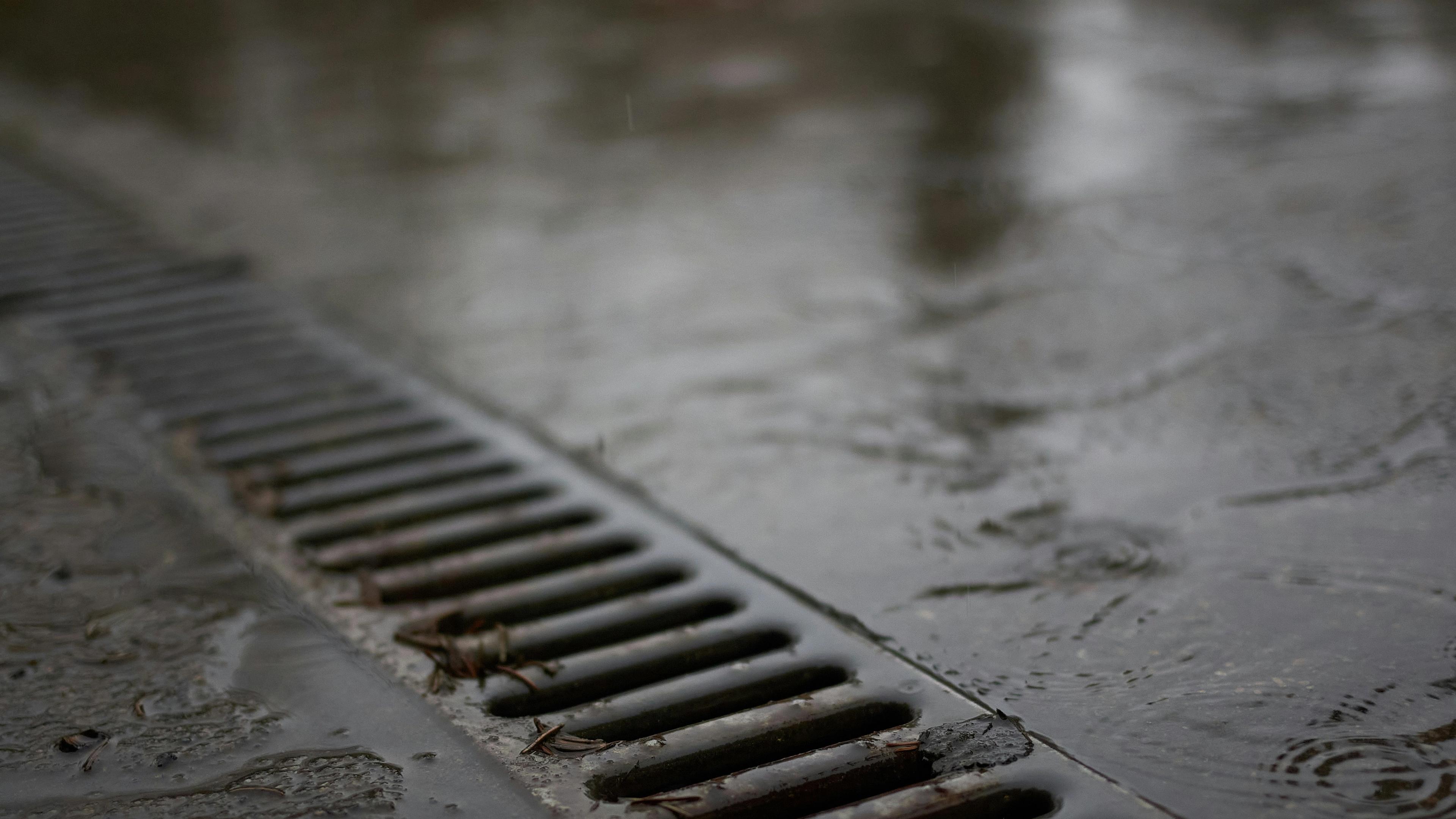 Drain up close with rain flowing into it