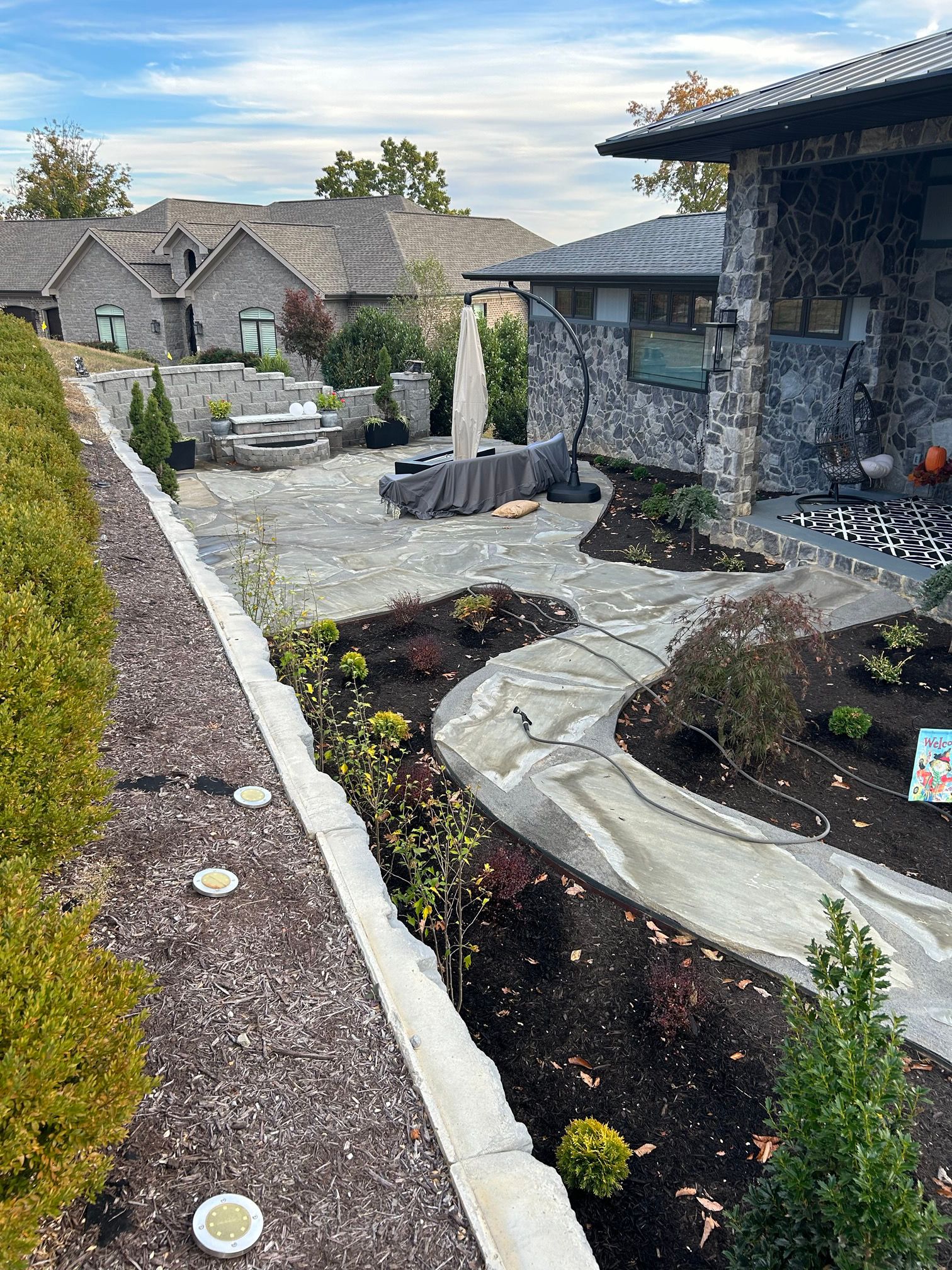 Backyard patio surrounded by tall retaining wall
