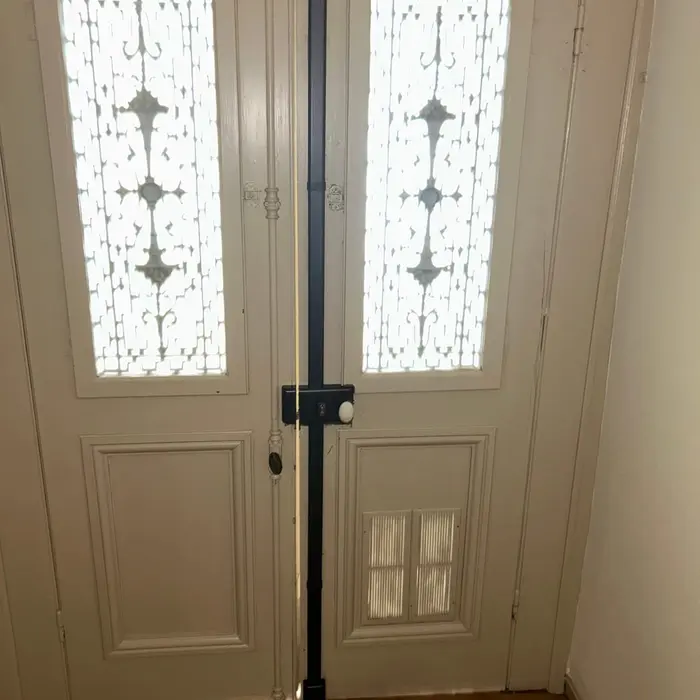 The same double door seen head-on, the black bar running full height between the two leaves