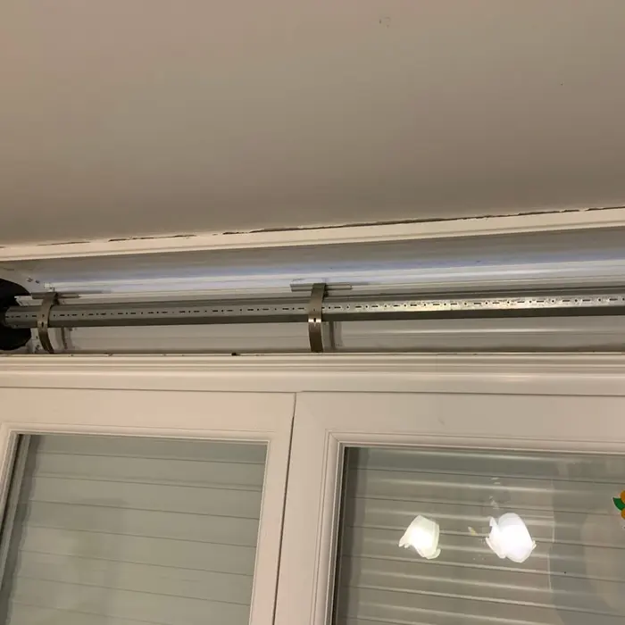Roller shutter mechanism fitted above a window, indoors