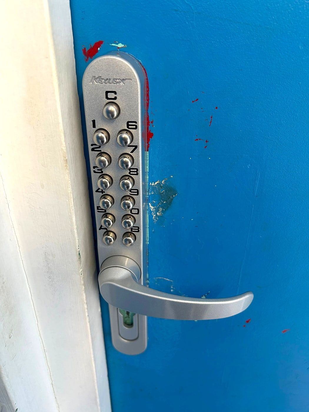 Keypad lock on a blue metal door