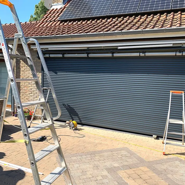 Wide roller shutter being fitted, ladder in place
