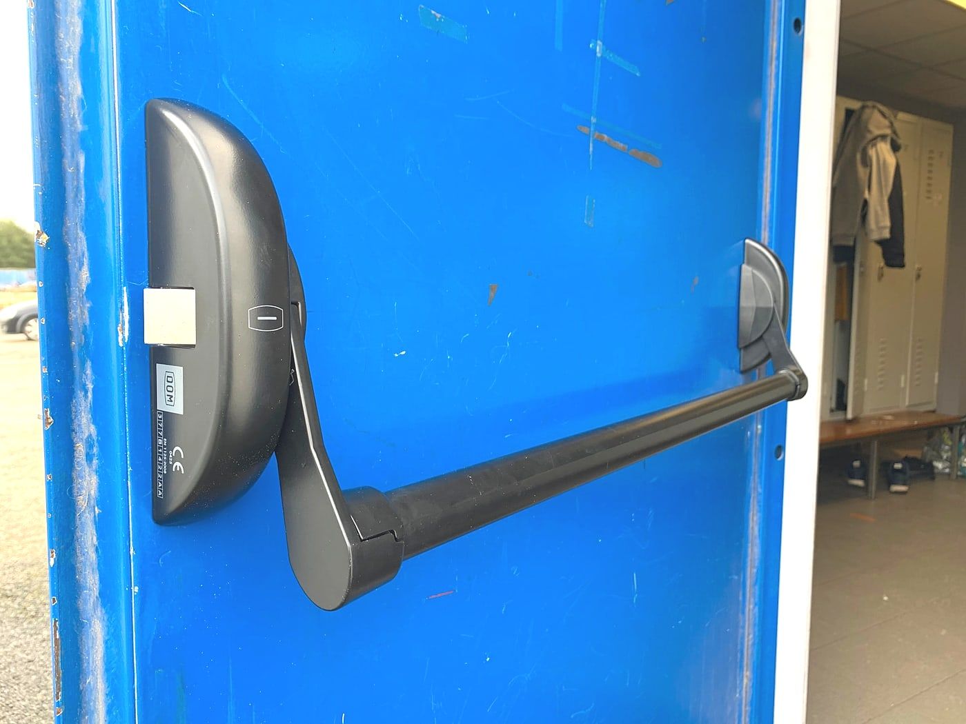 Horizontal push bar on a blue door