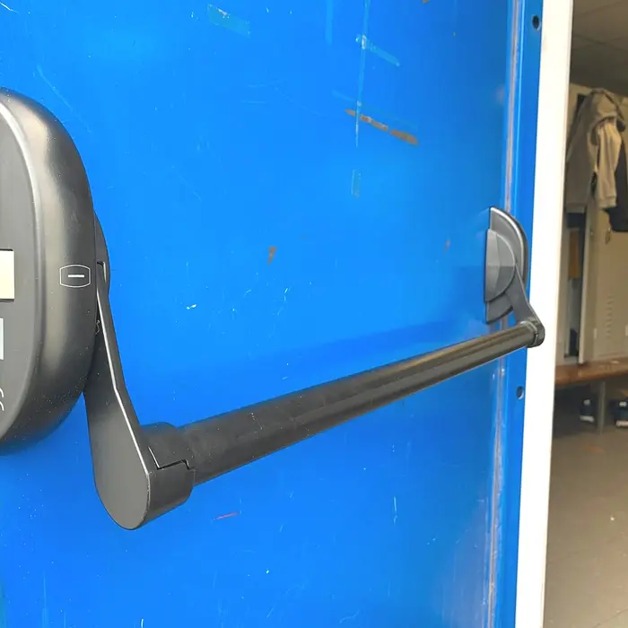 Horizontal push bar on a blue door