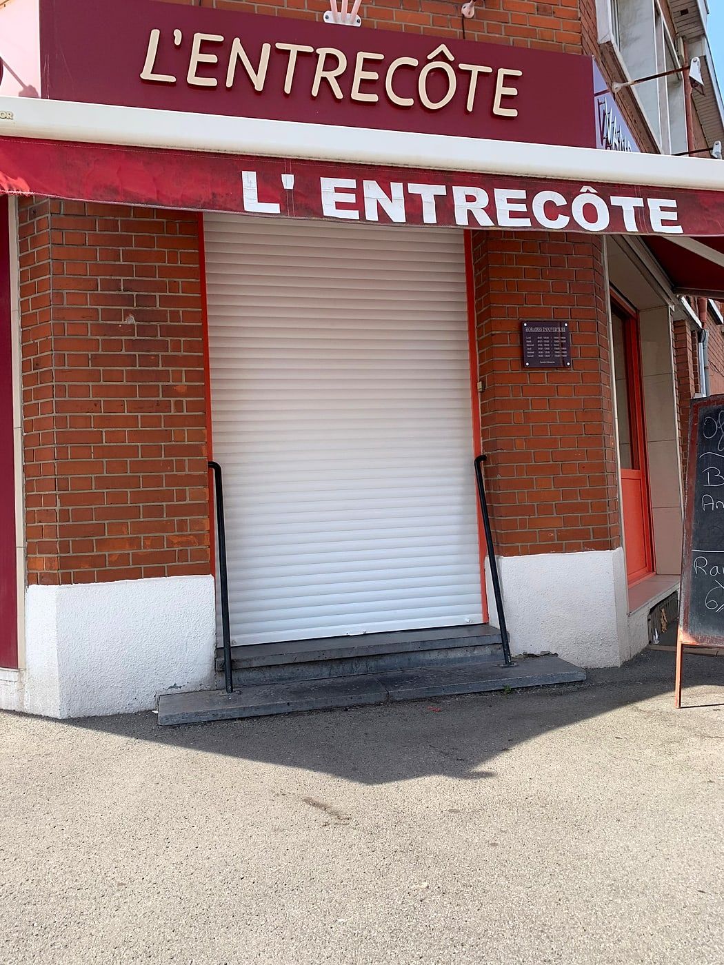 Restaurant shopfront fitted with a metal roller shutter