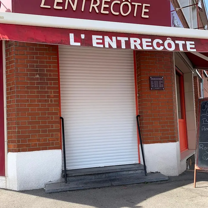 Restaurant shopfront fitted with a metal roller shutter