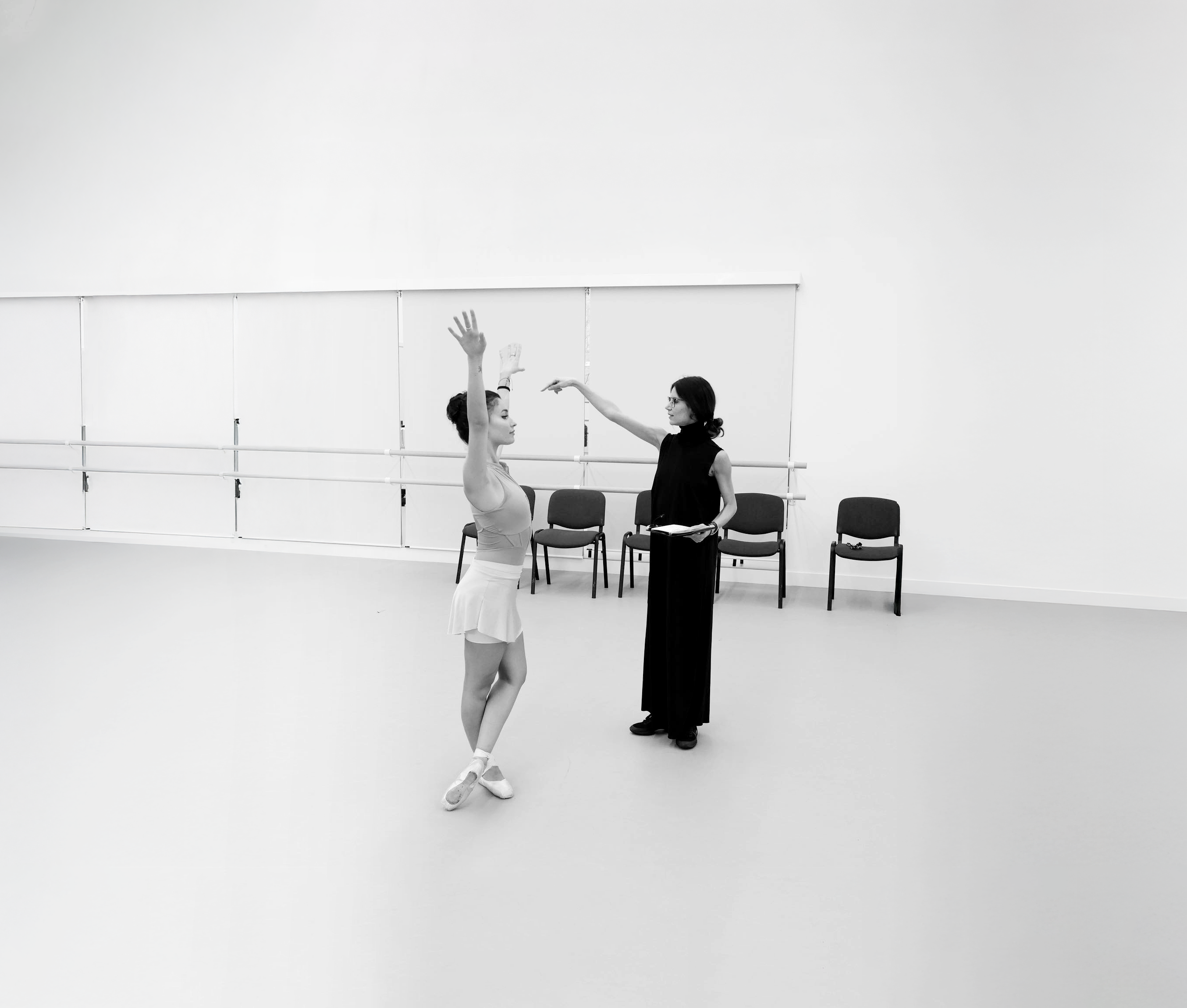 Photograph of a dancer being instructed