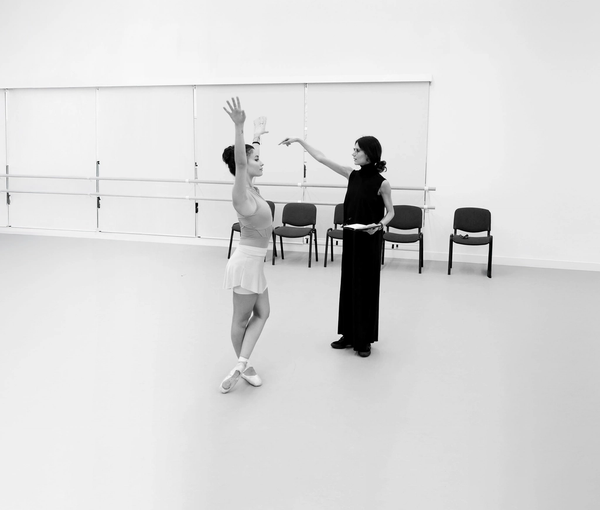 Photograph of a dancer being instructed