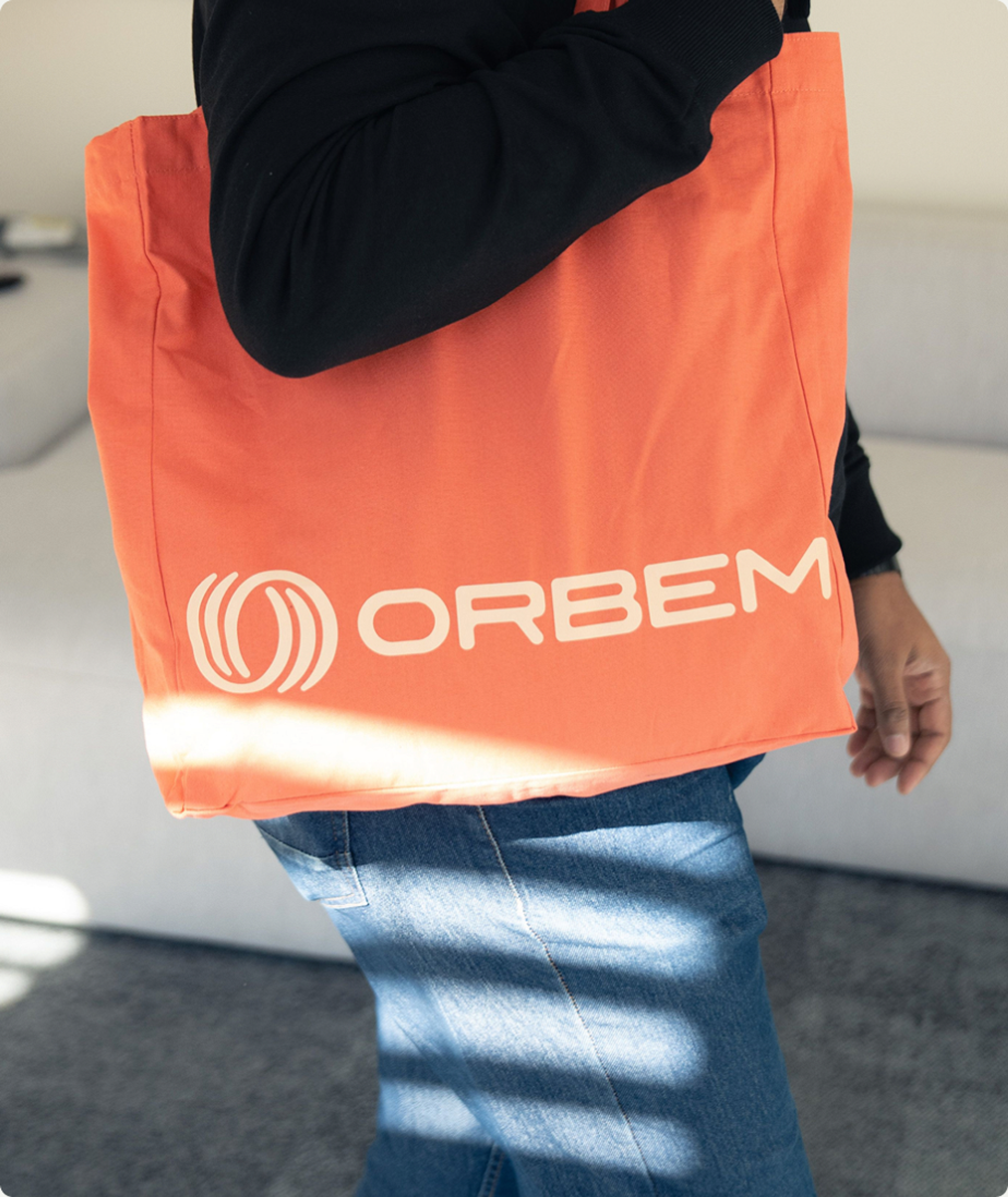 Orange Orbem tote bag carried over a shoulder